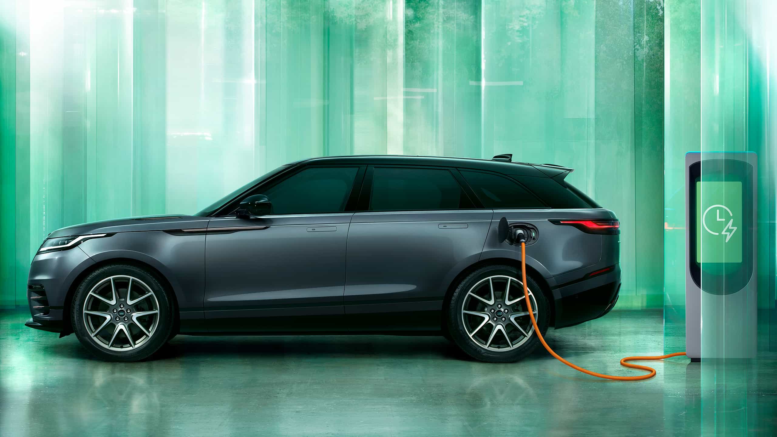 Parked Range Rover velar charging at the phev station point