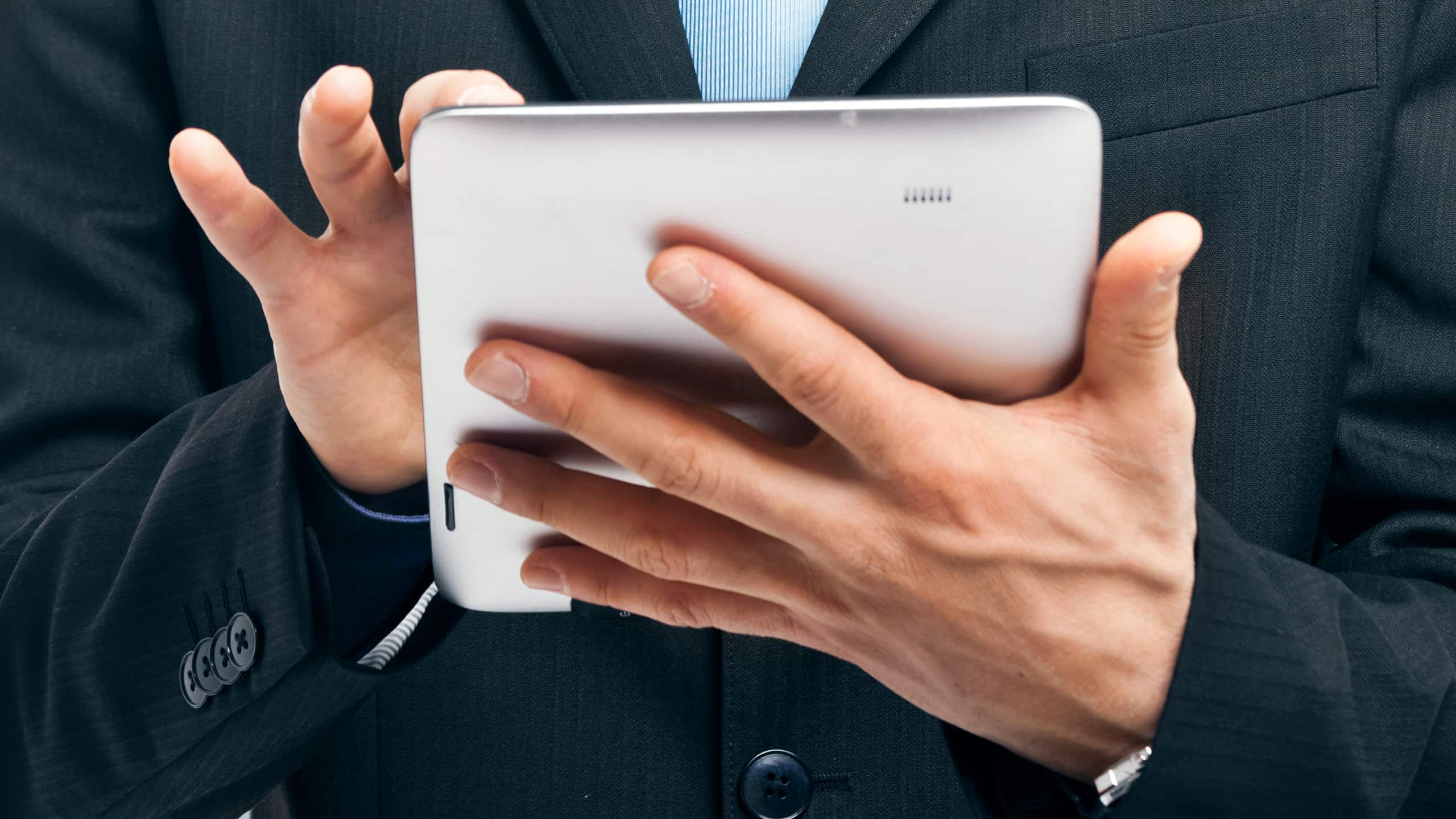 Closeup view of man checking tablet