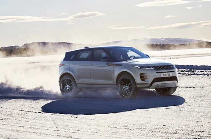 White Range Rover drive through snow