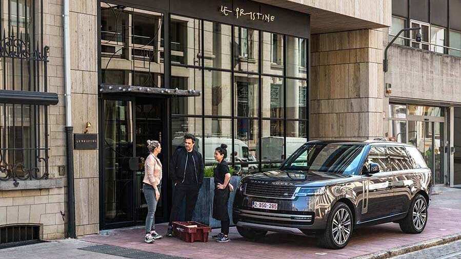 Land Rover Vehicle outside a Restaurant with People